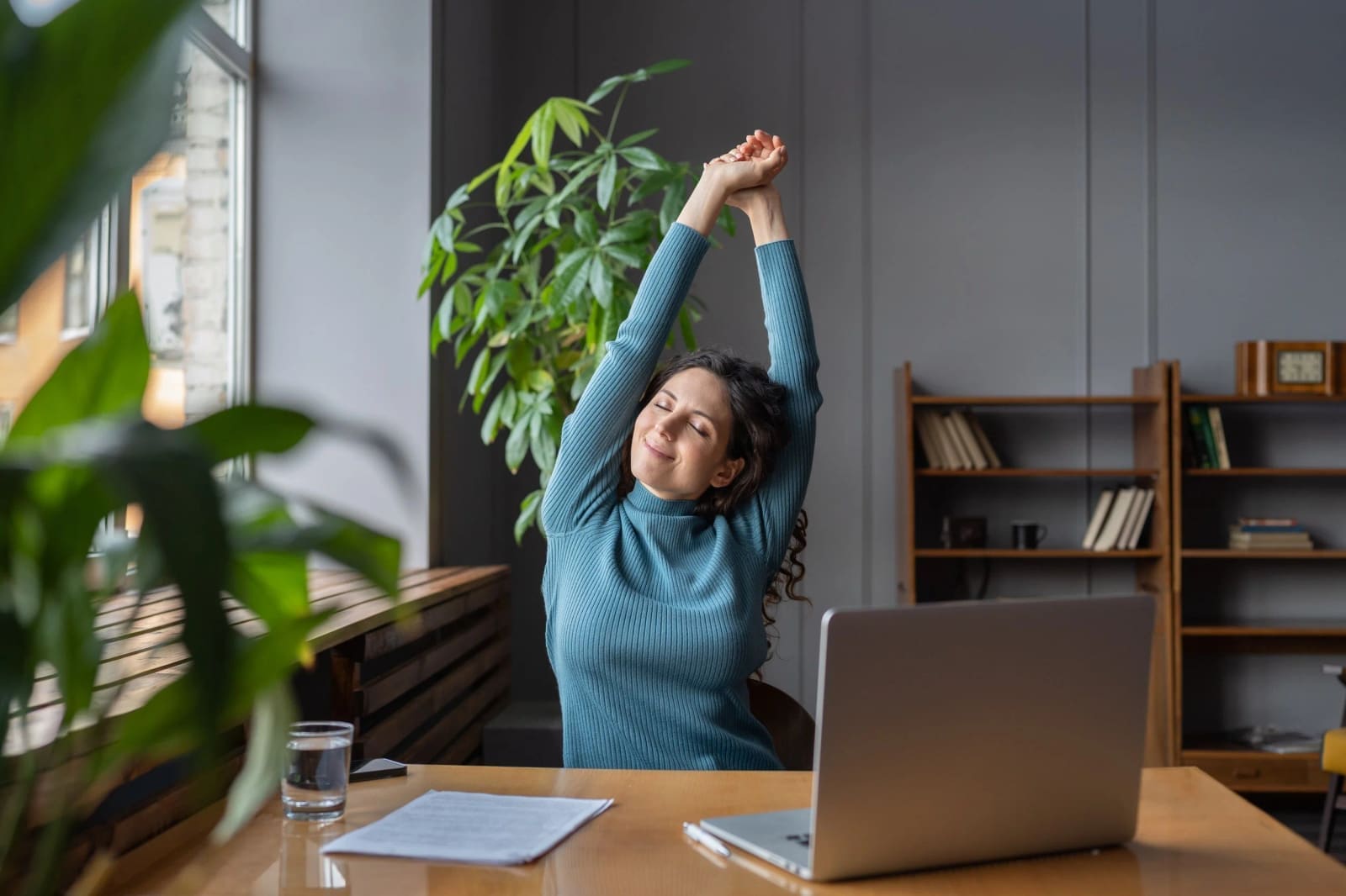 Carolyn Silan demonstrating a seated stretch to relieve the strain of prolonged sitting