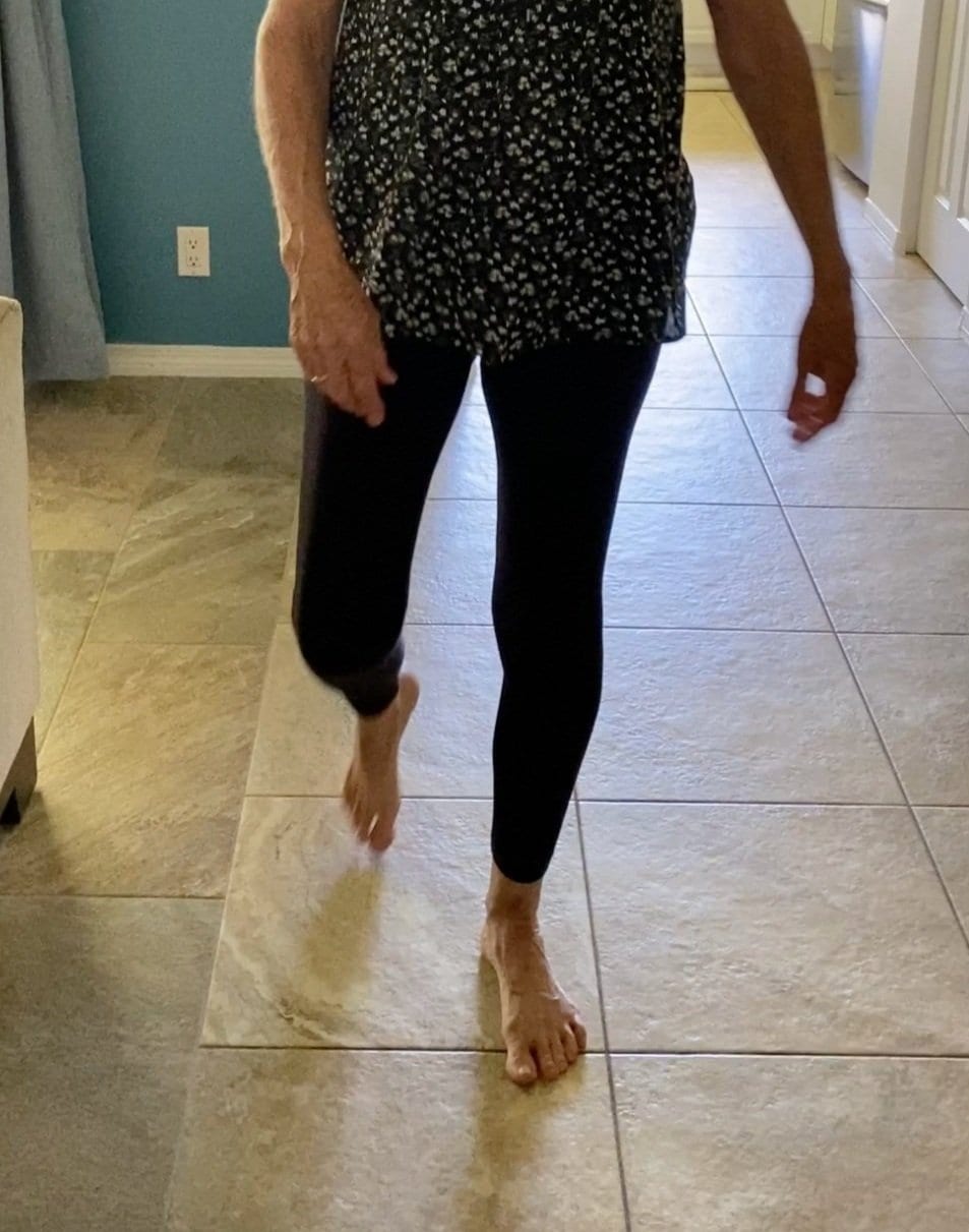 Person walking barefoot across a tiled floor