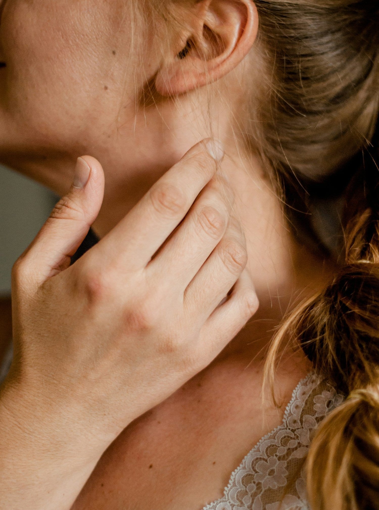 Person tilting their head down to look at a phone, the forward posture that loads the neck with extra weight