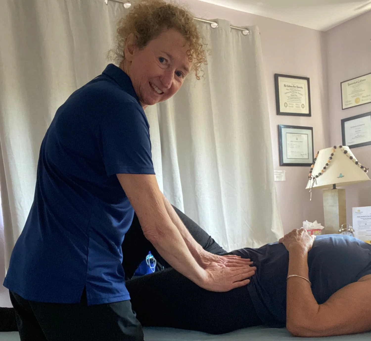Therapist treating a patient lying face down