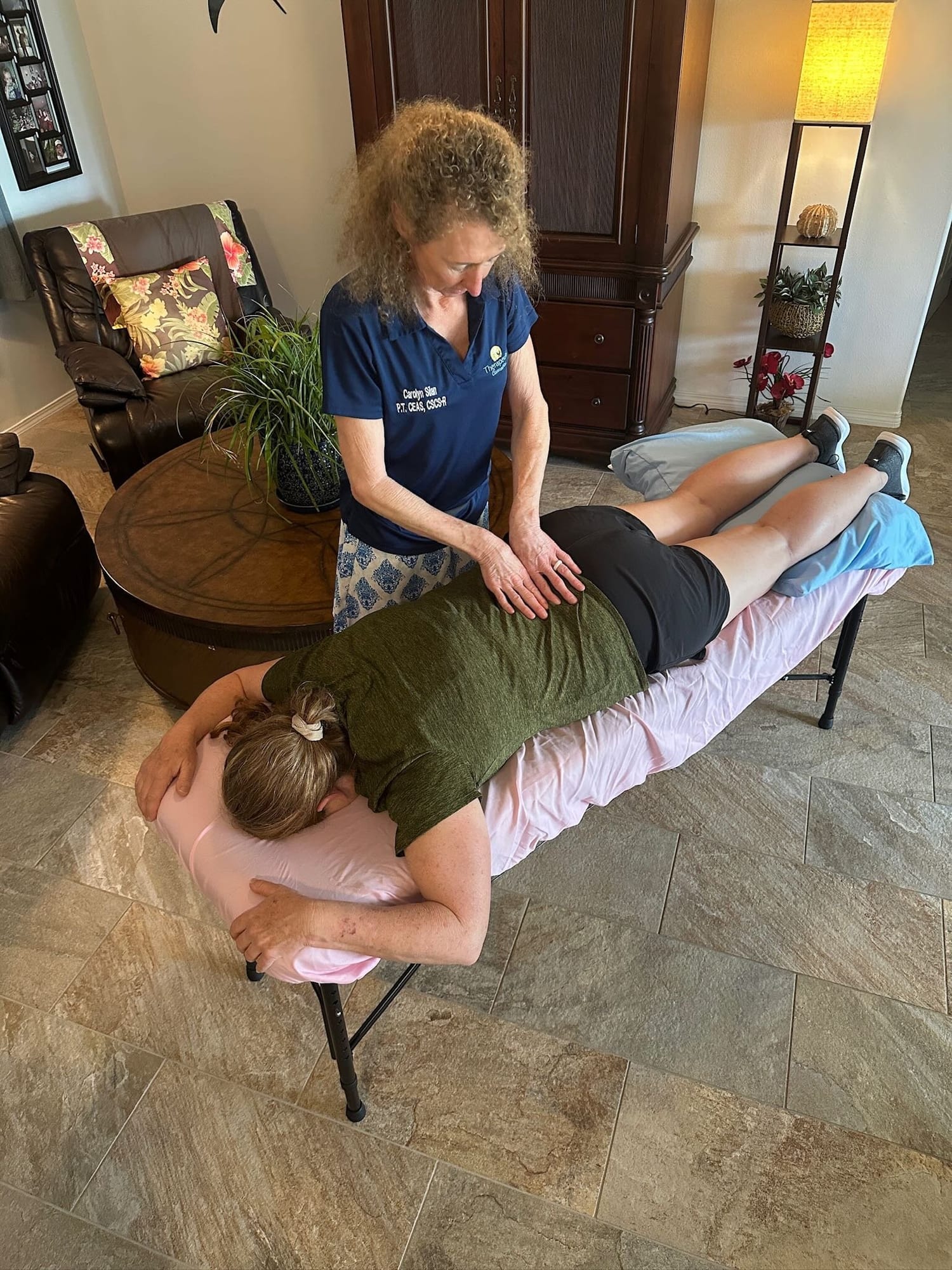Person holding their lower back