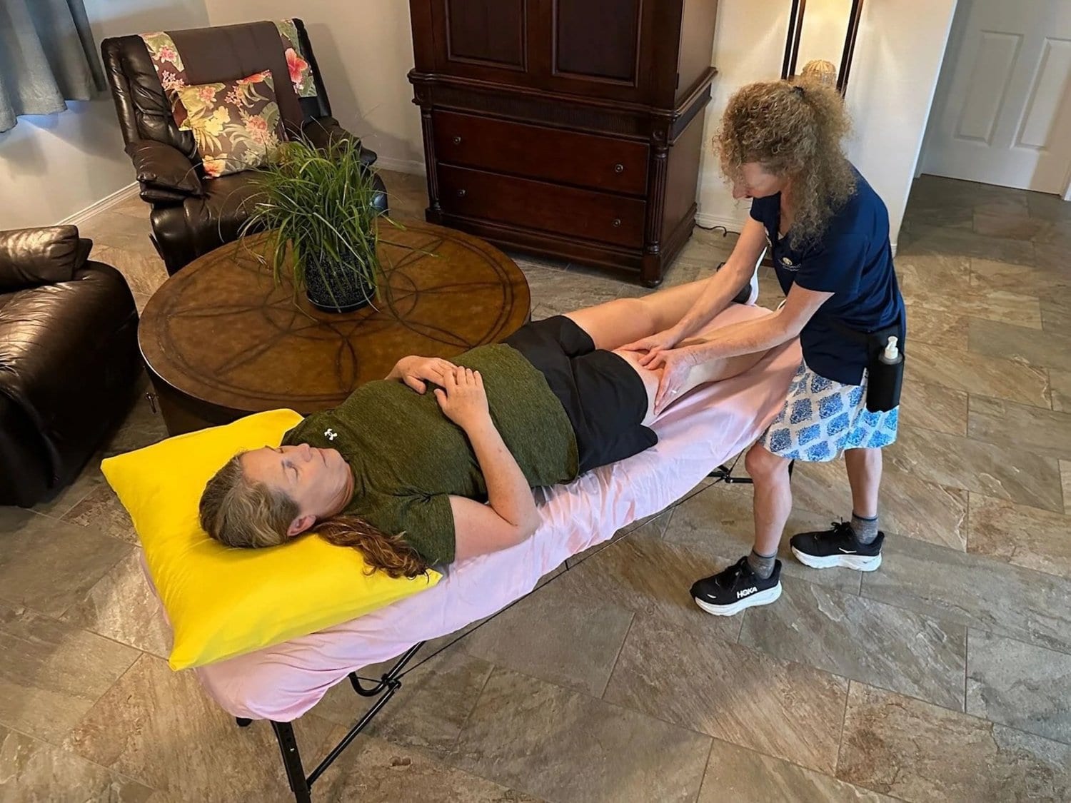 Patient receiving treatment on a massage table at home