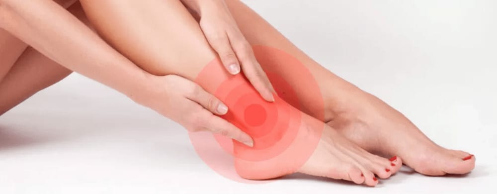 Person holding their ankle, highlighted to indicate pain