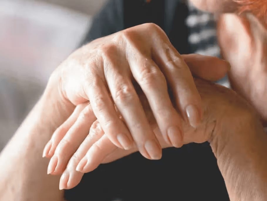 Close-up of an older and a younger hand clasped together