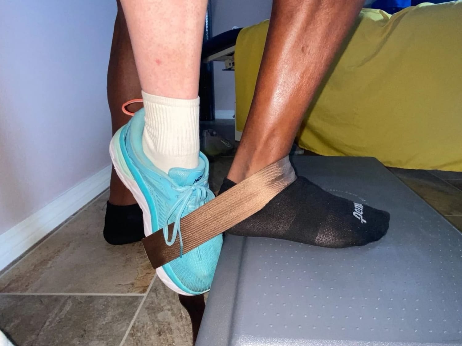 Person holding their ankle, indicating pain