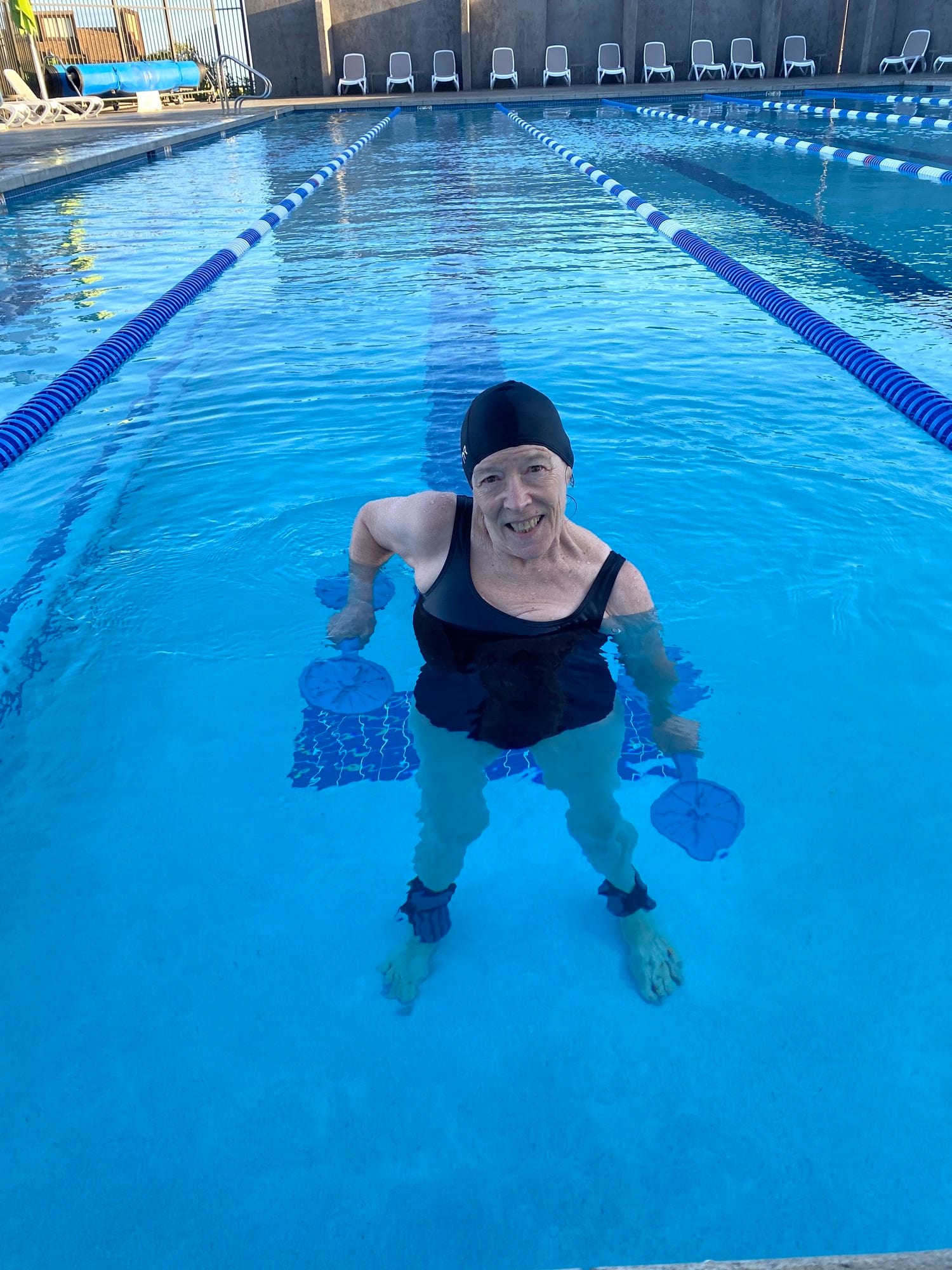 Carolyn Silan exercising in a swimming pool during aquatic therapy