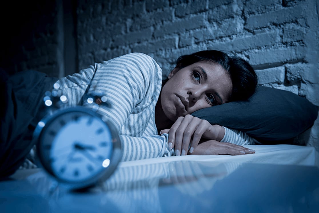 A person resting peacefully in bed