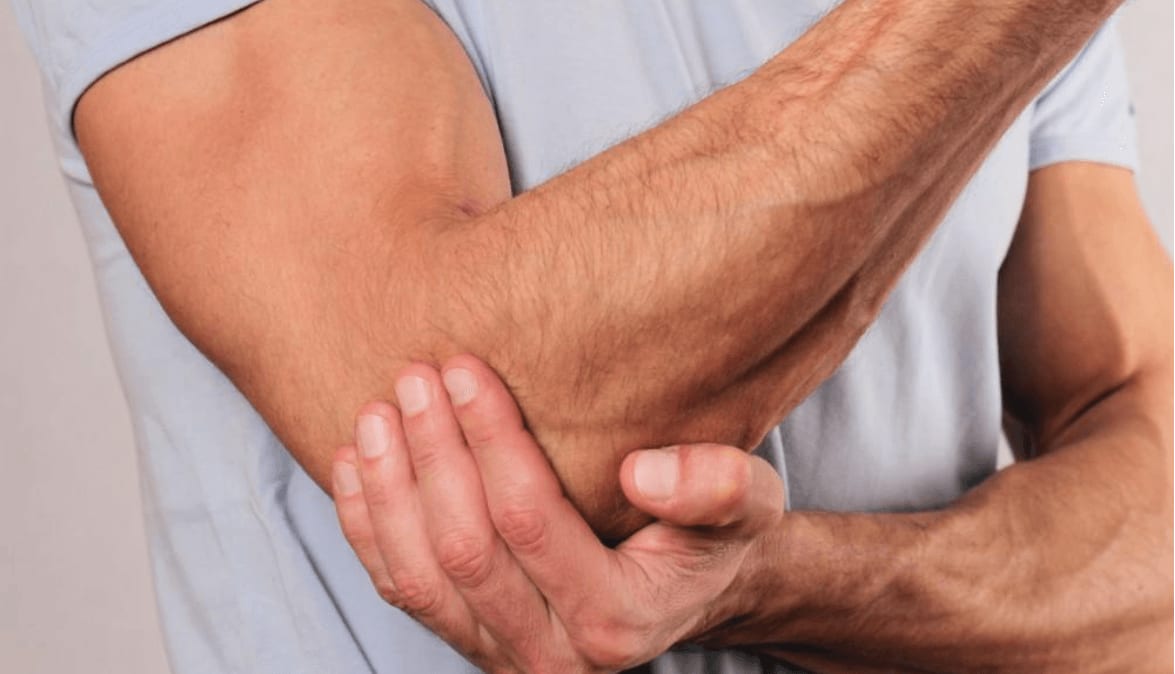 Person holding their elbow, indicating pain