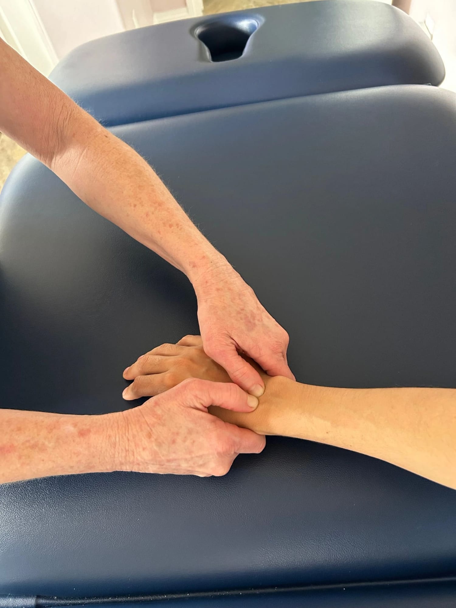 Carolyn Silan performing a hand and wrist manual therapy technique