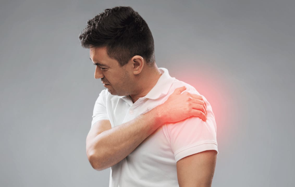 Man holding his shoulder, indicating pain
