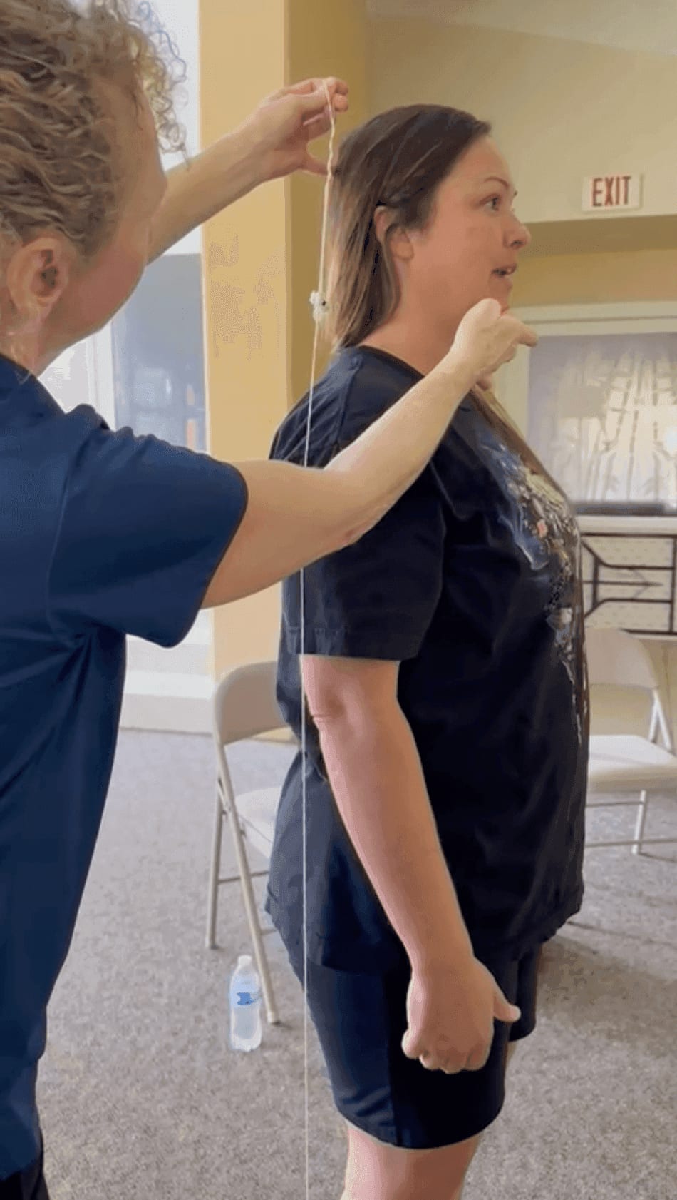 Carolyn demonstrating a plumb-line postural assessment